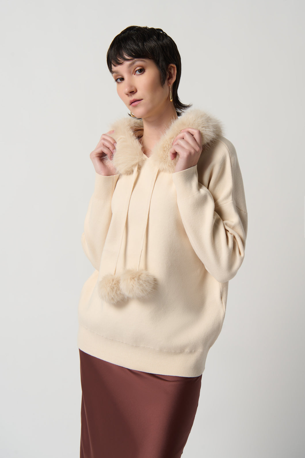 Joseph Ribkoff Almond Sweater With Faux Fur Hood And Pompoms